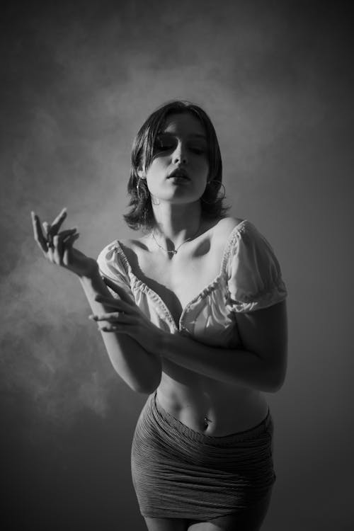 Grayscale Photo of Woman in White Crop Top and Skirt