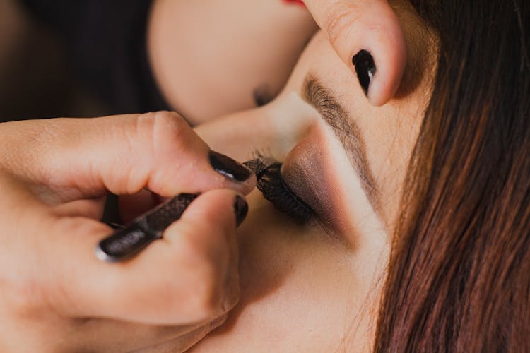 Woman Putting False Eyelashes