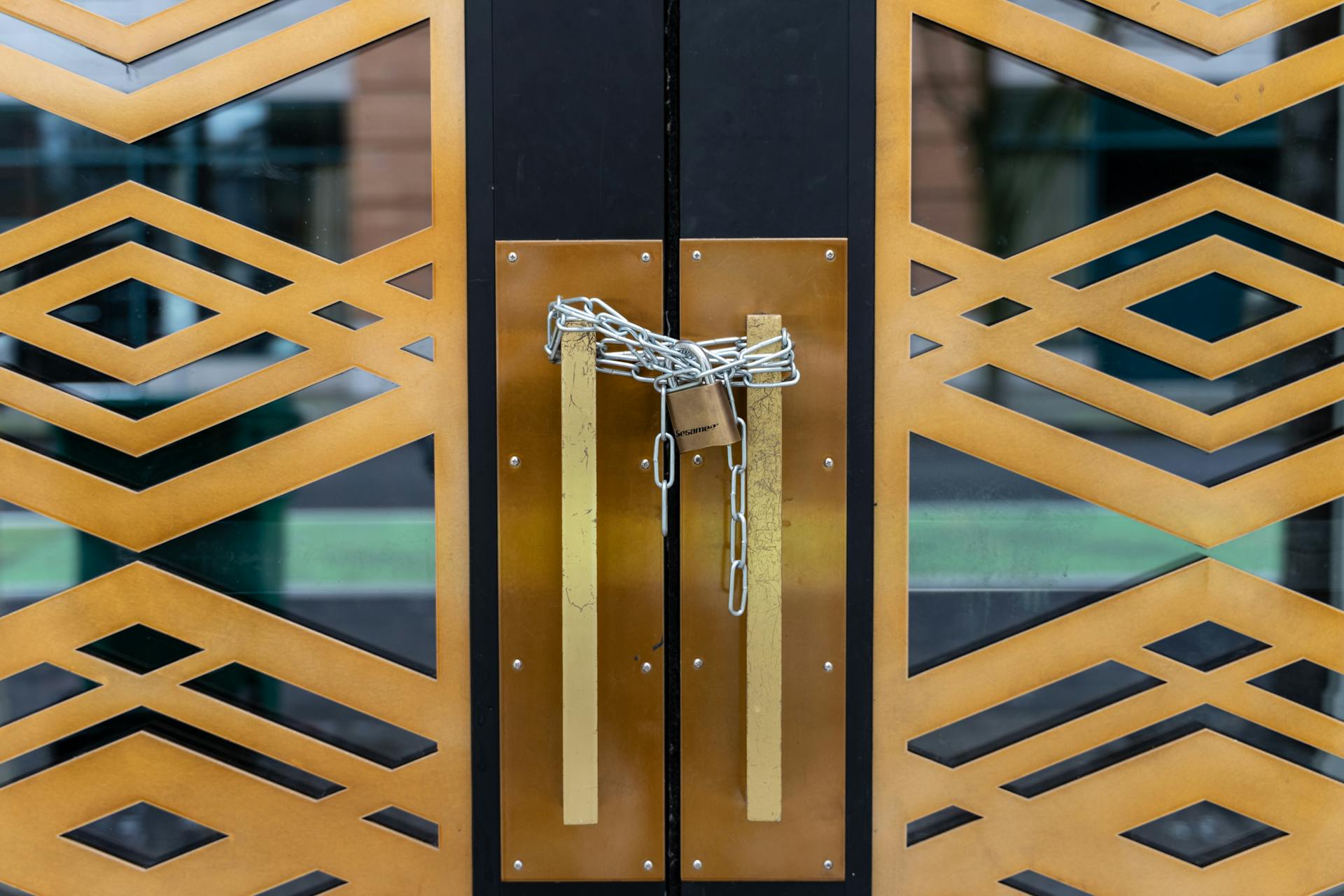 A stylish geometric door locked with a chain, conveying security in Portland.