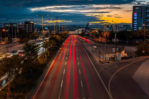 Free Vibrant long exposure photo of Ankara highway at dusk with light trails and city lights. Stock Photo