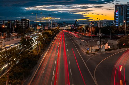 Free Dramatic sunset over Ankara cityscape with vibrant light trails from traffic, capturing urban energy. Stock Photo