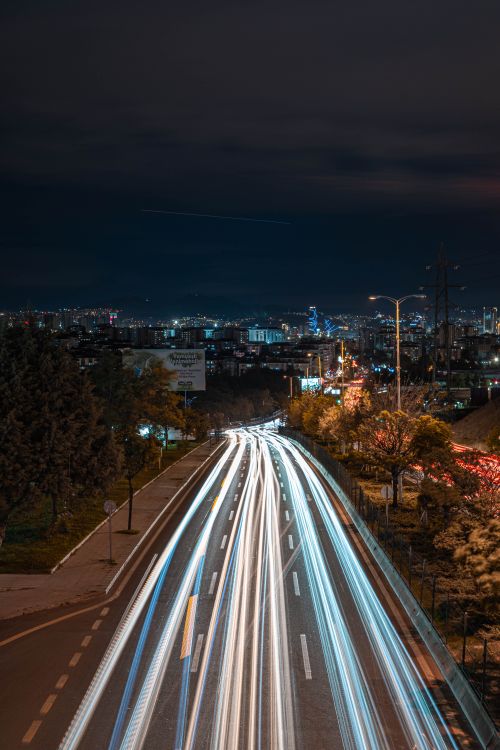 Free Dynamic night view of Ankara with vibrant light trails and city skyline under a dark sky. Stock Photo