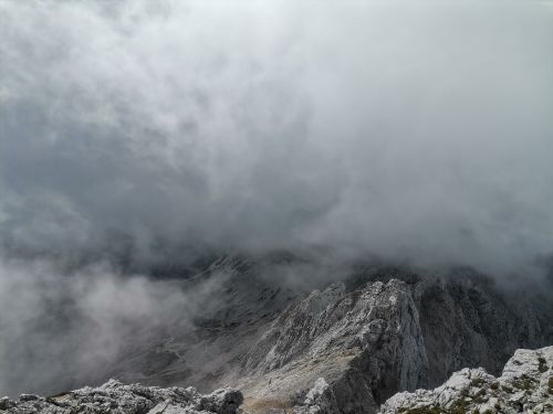 Free A dramatic view of the fog-covered Kamnik Alps mountains in Slovenia. Stock Photo