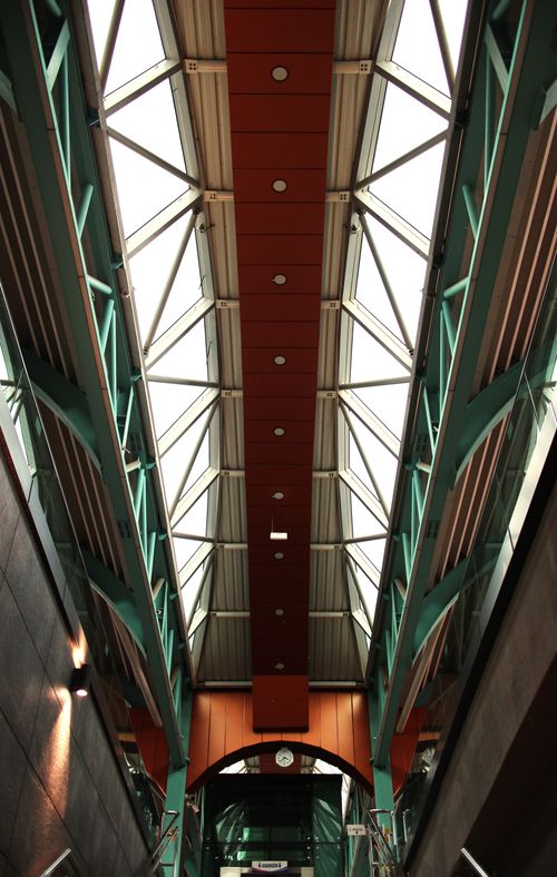 Free Interior view of a modern structure with geometric skylights and steel beams. Stock Photo