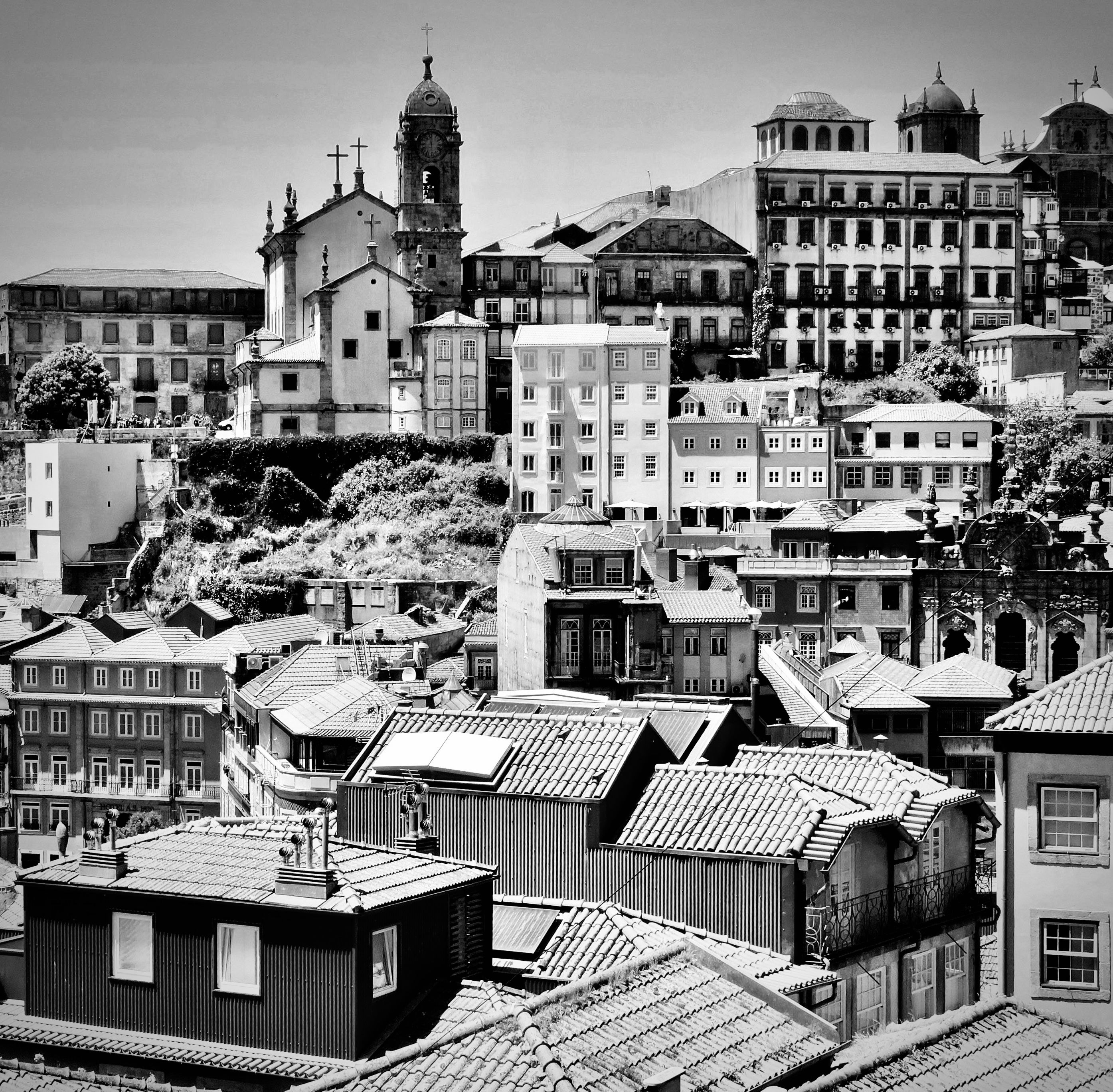 A black and white view of Porto's iconic rooftops and historical buildings on a sunny day.