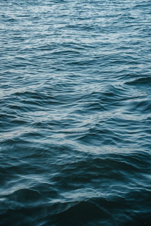Free A serene view of ocean waves gently moving, captured in Tadoussac, Québec, Canada. Stock Photo