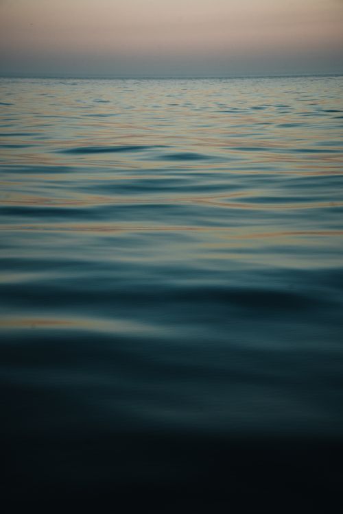 Free Gently rippling ocean waves under a twilight sky in Tadoussac, Québec, Canada. Stock Photo