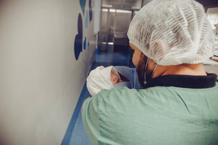 Man Carrying Newborn Baby