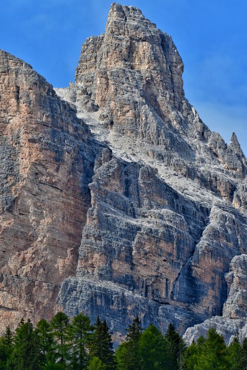 Free A breathtaking view of a rugged mountain peak in the Dolomites, Italy, under a clear blue sky. Stock Photo