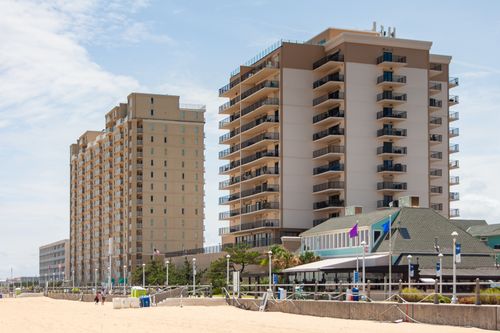 Free Contemporary beachfront hotels overlooking the sandy shores of Virginia Beach on a sunny day. Stock Photo