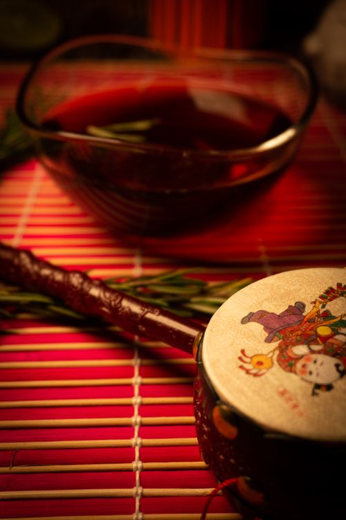 Free A serene oriental tea setup with traditional motifs and a rich red beverage, perfect for cultural and culinary themes. Stock Photo