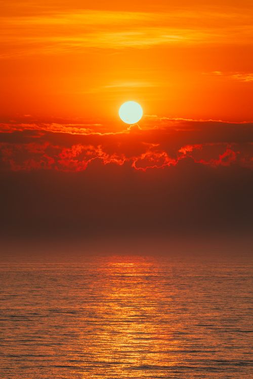 Free Stunning sunrise with vibrant orange hues over the ocean at Cửa Tùng, Vietnam. Stock Photo