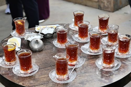 Free A collection of Turkish tea glasses and silverware on a wooden table, outdoors. Stock Photo