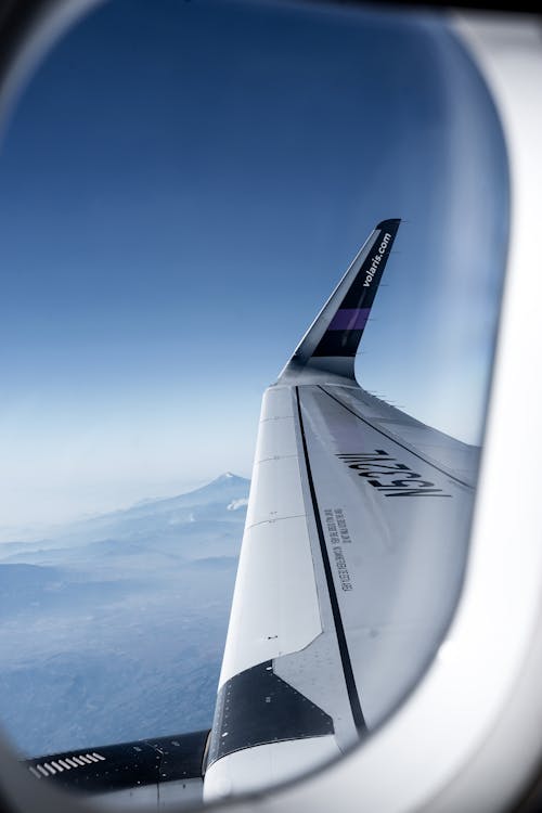 Free White Airplane Wing through a Window Pane Stock Photo