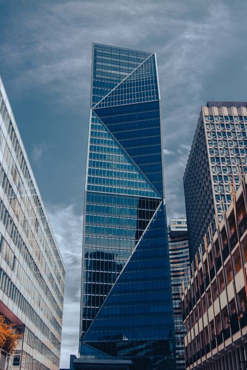 Free Tall glass skyscraper in La Défense, Paris with a geometric facade under a clear sky. Stock Photo