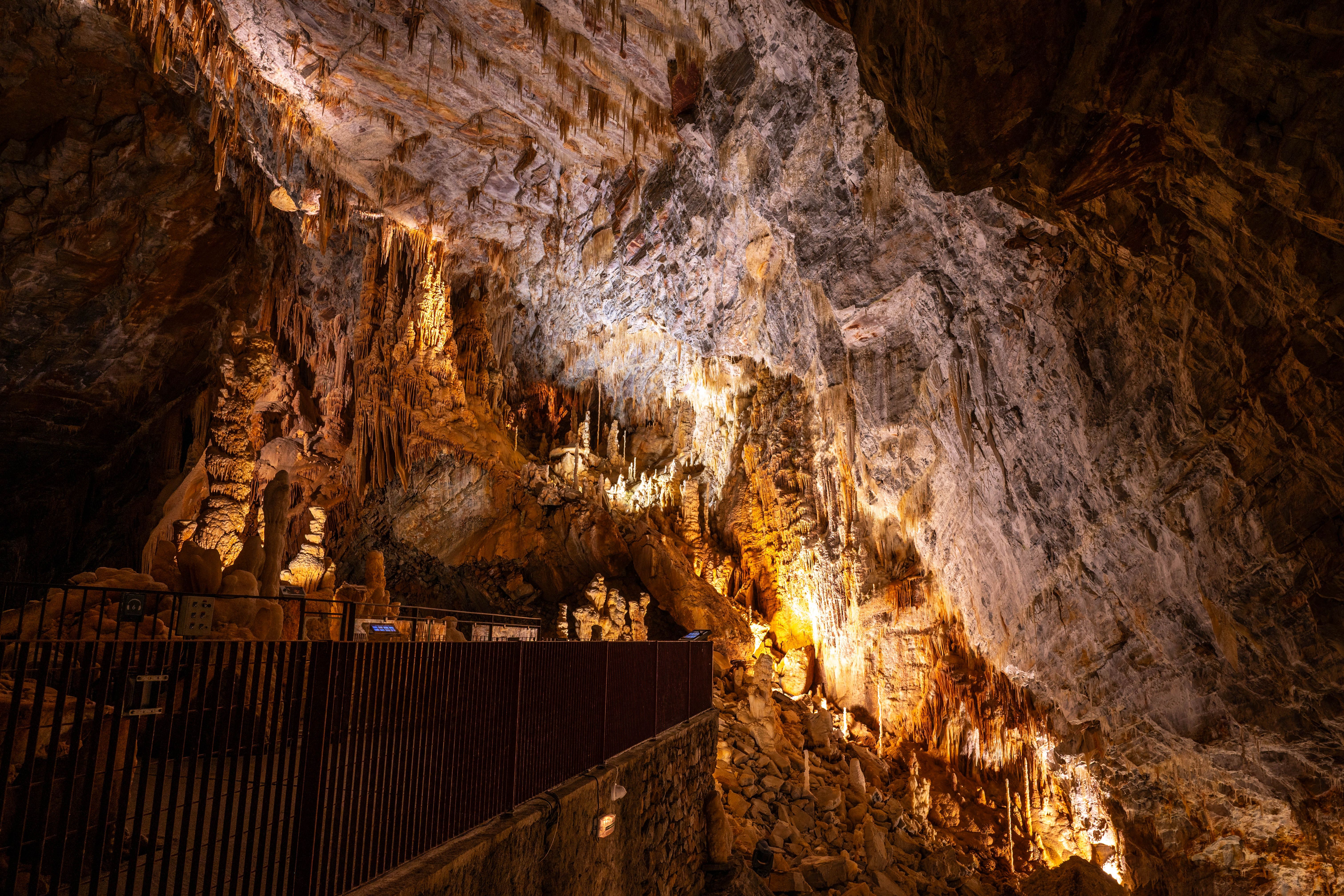 Stunning illuminated stalactites and stalagmites in a cavern in Cabrespine, France.