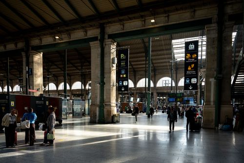Free Busy interior shot of Gare du Nord showcasing travelers and iconic architecture. Stock Photo