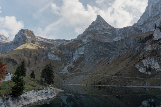 Explore the stunning alpine lake surrounded by majestic mountains in Wolfenschiessen, Switzerland.