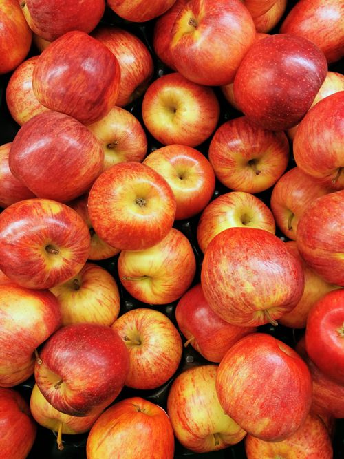 Free A vibrant assortment of fresh red apples in various shades and textures. Stock Photo