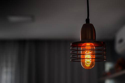 Orange Light Bulb Turned on in Close Up Photography