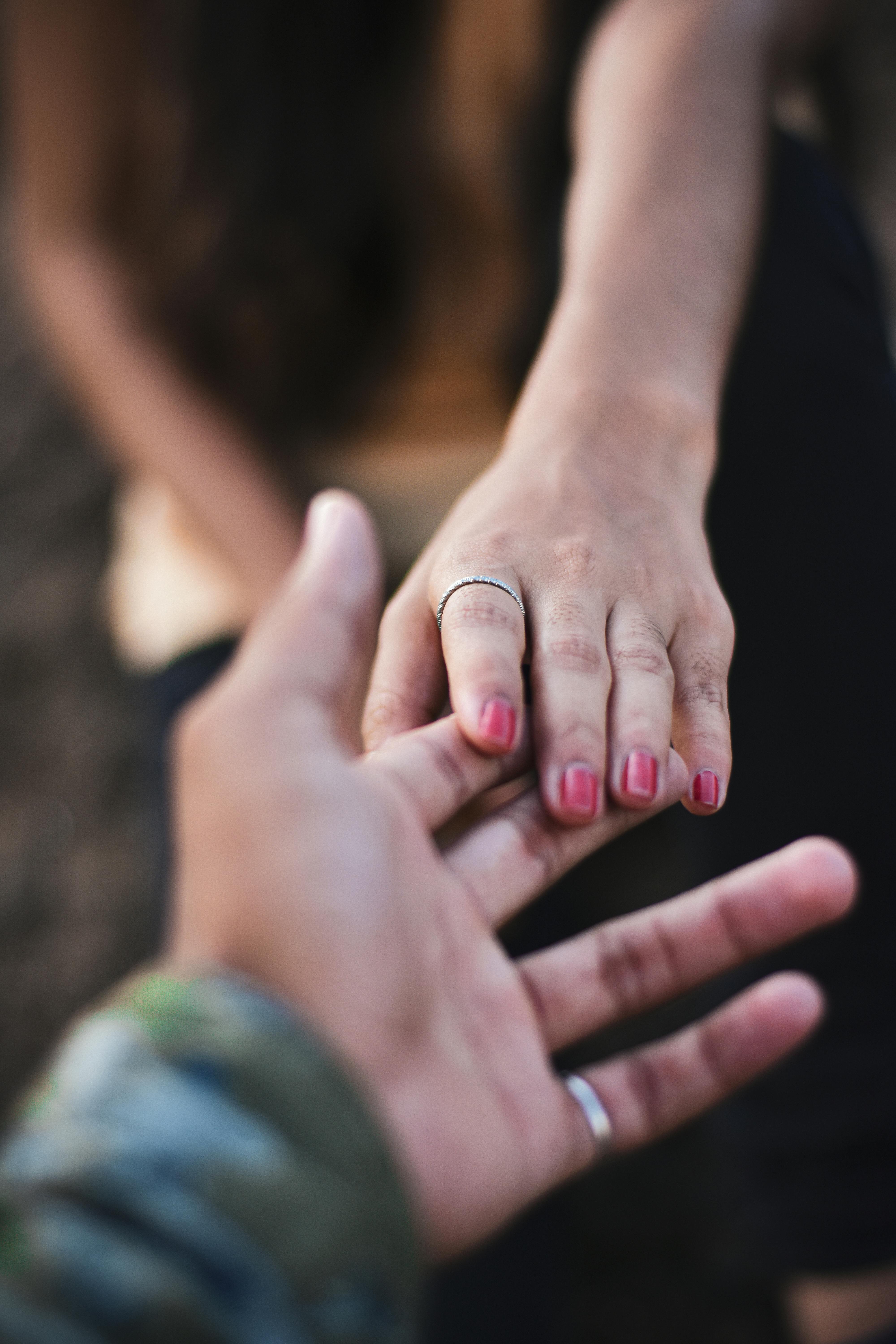 Man and Woman Interlocking Index Fingers With Anchor Tattoos · Free