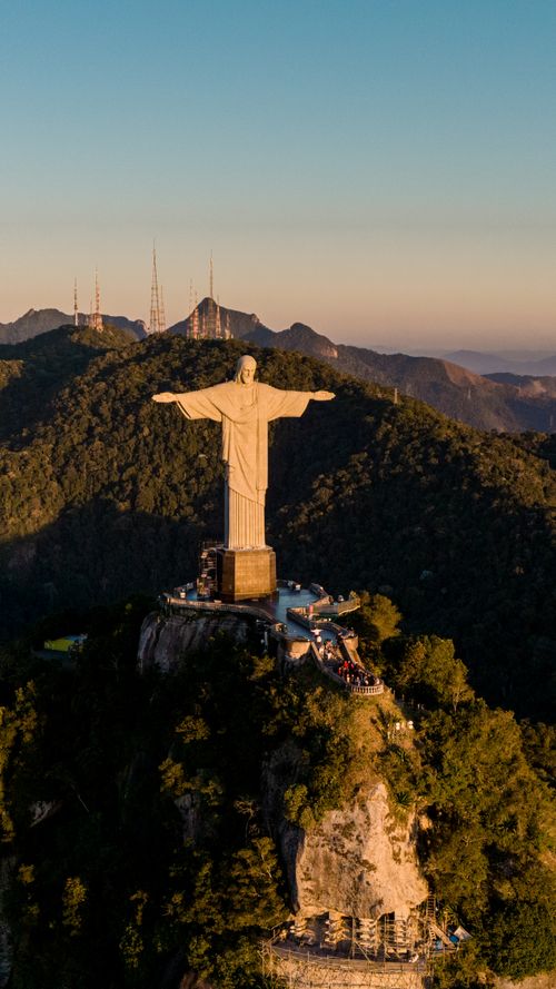 Free A stunning aerial shot of Christ the Redeemer statue in Rio de Janeiro during sunset. Stock Photo