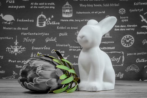 White Ceramic Bunny Figurine Beside Flower