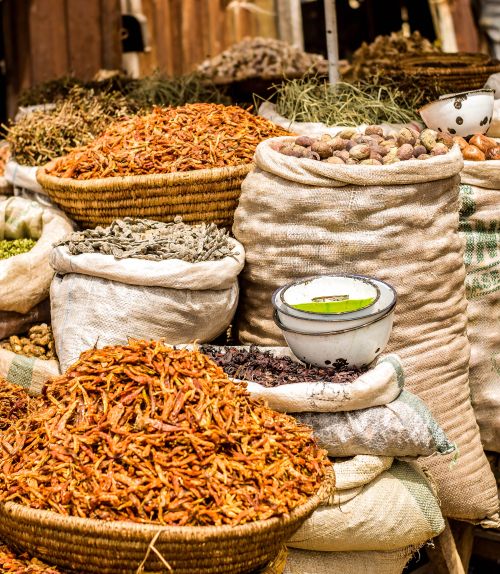 Free Colorful market scene with sacks of spices, beans, and dried goods, showcasing diverse culinary ingredients. Stock Photo