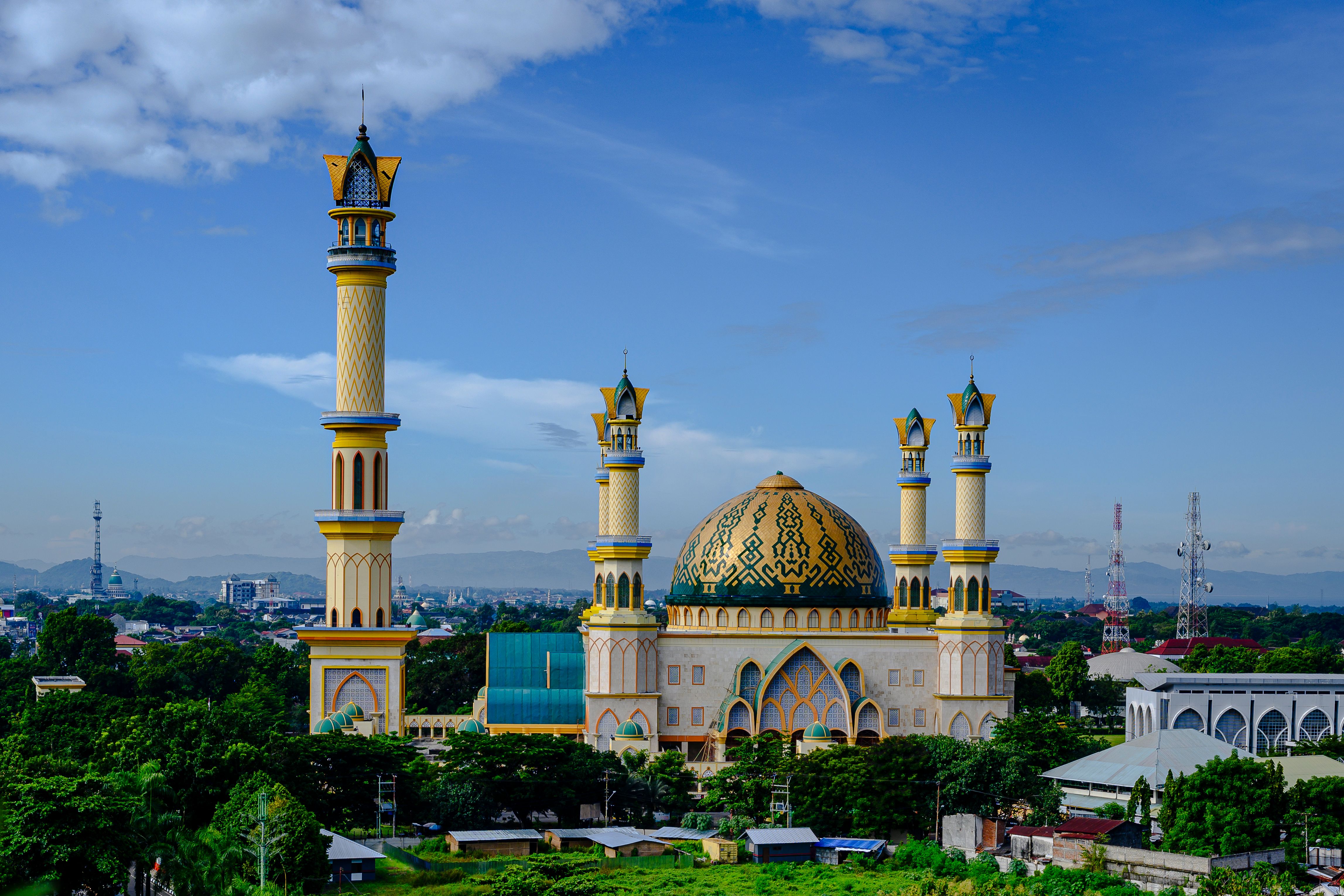 Aerial view of the iconic Islamic Center Mosque in Mataram, Lombok, Indonesia, under a clear blue sky.