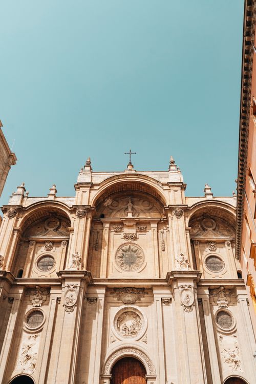 Free Beautifully detailed Renaissance architecture of a historic cathedral under a clear blue sky. Stock Photo