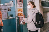 Woman in Gray Hoodie Waiting in Line