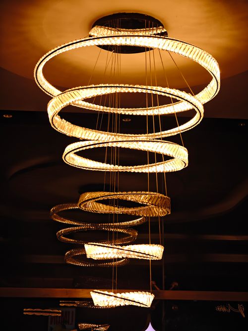 Free A stylish spiral chandelier casting warm, ambient lighting indoors. Stock Photo