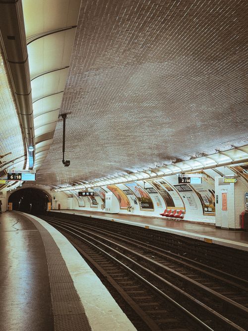 Free Artistic capture of an empty Paris metro station with curved ceilings and platform view. Stock Photo