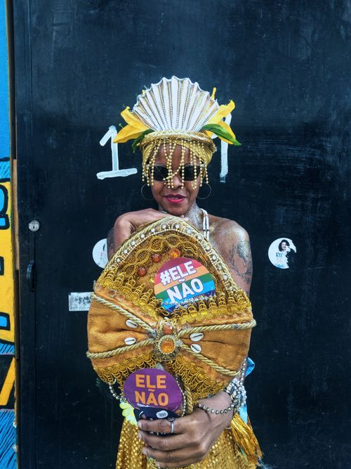 Free Woman in traditional Brazilian attire holding political message in Rio de Janeiro. Stock Photo