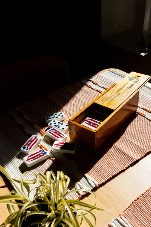 Free Captivating domino game set featuring Puerto Rico flag tiles on a wooden table. Stock Photo
