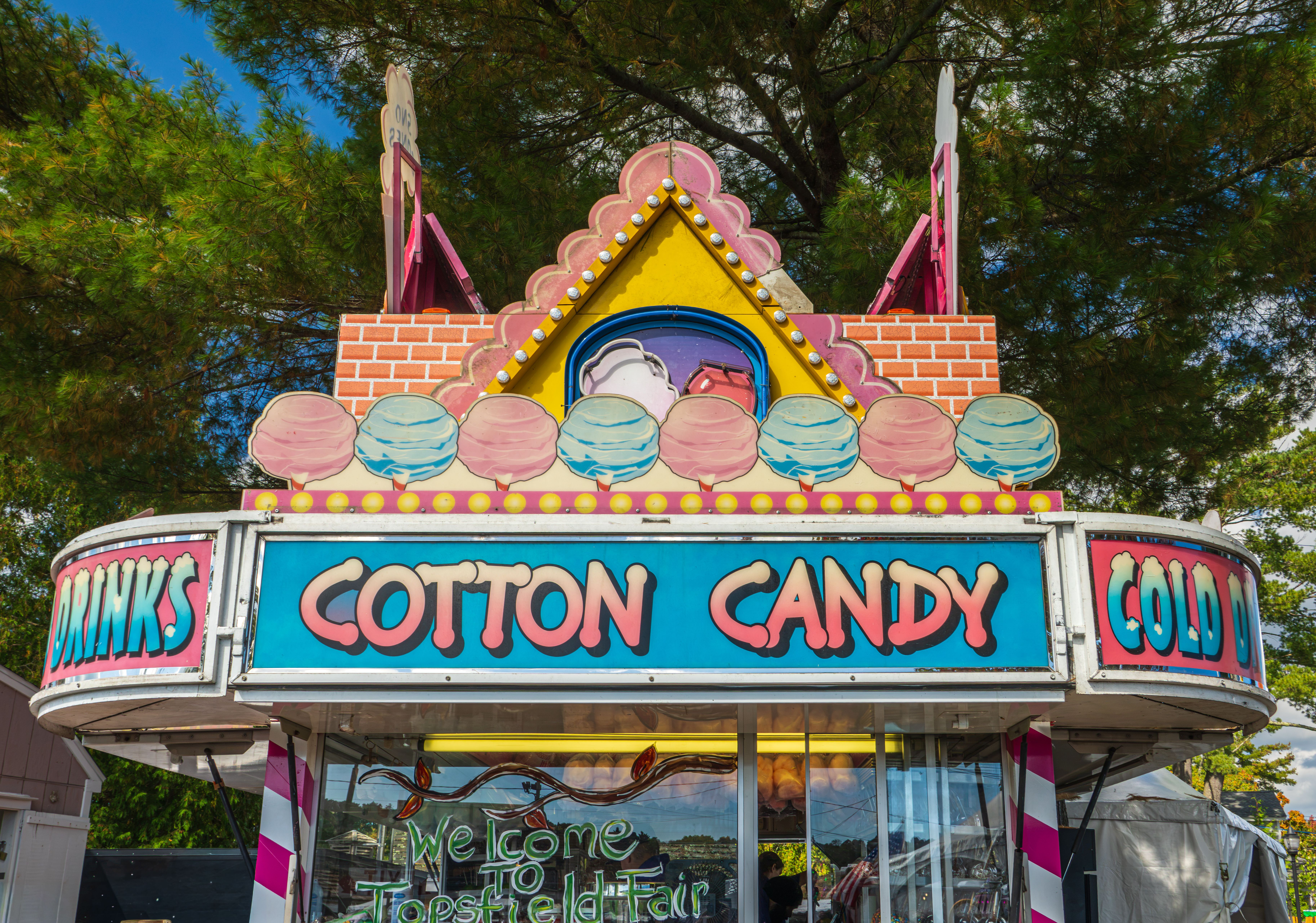 Vibrant cotton candy stand at Topsfield Fair with signage and festive decorations.