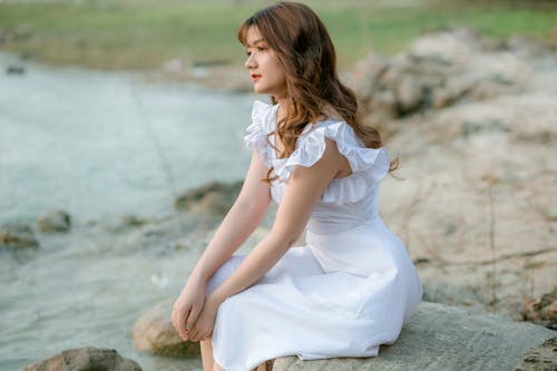 Elegant woman thoughtfully looking away in nature