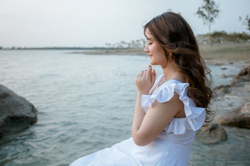 Cheerful woman with closed eyes on seafront