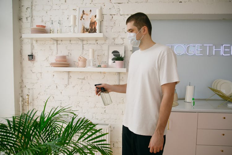 Man Watering The Plants