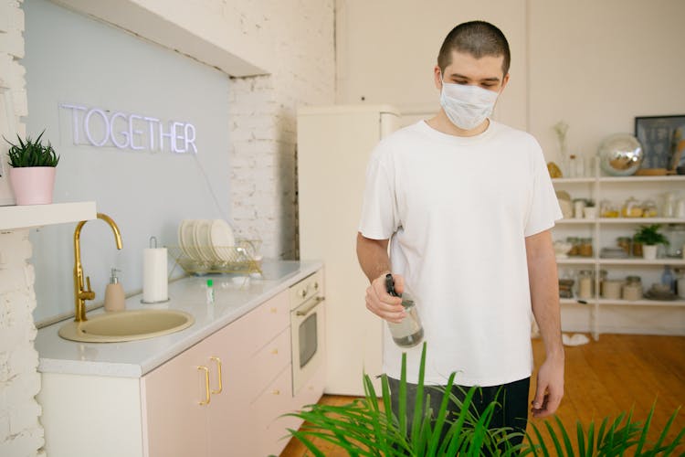 Man Watering The Plants