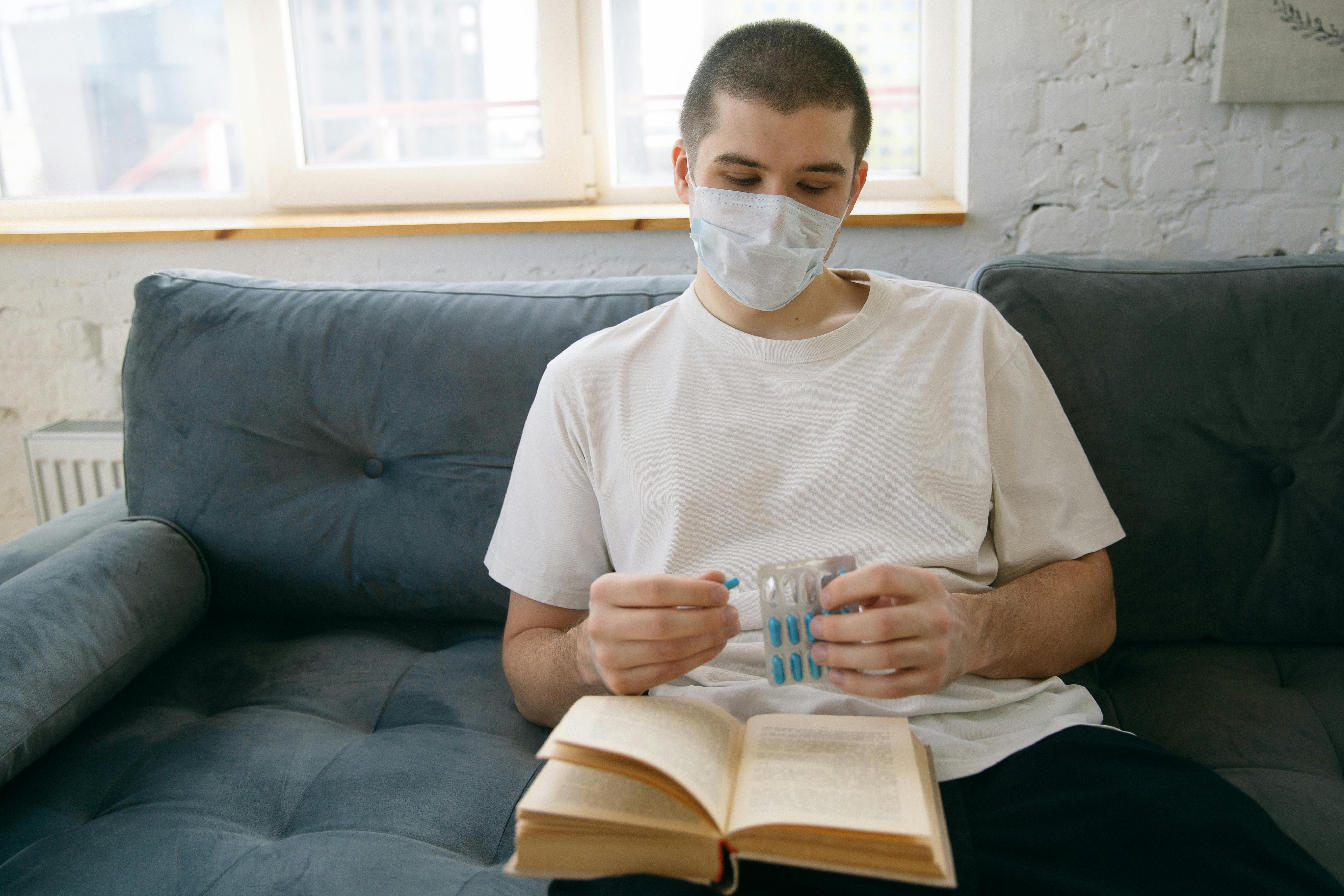 man in white crew neck t shirt wearing facemask