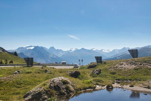 Stunning view of mountains and road in Livigno, Italy, on a clear sunny day.