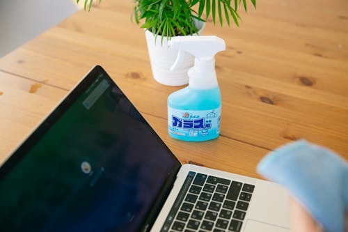 Free Disinfectant Spray Near Laptop Stock Photo