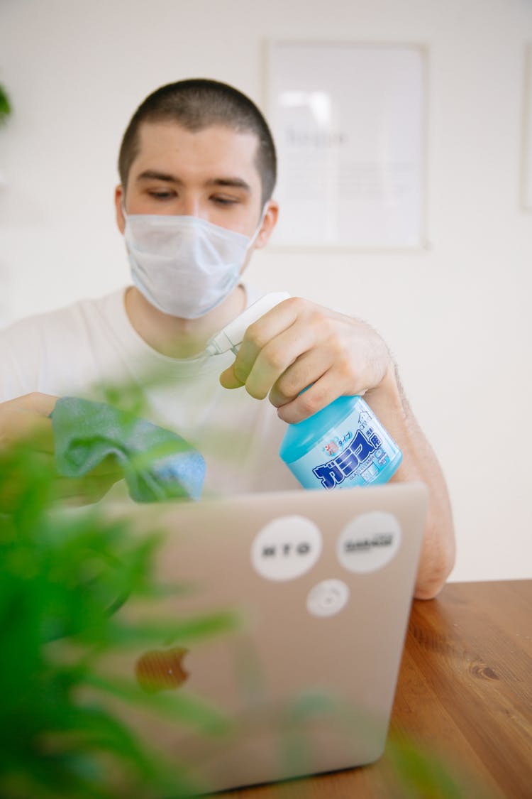 Man Holding Disinfectant Spray Bottle