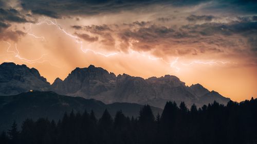 Free A striking view of the Dolomites under a thunderstorm and twilight sky, showcasing nature's power. Stock Photo