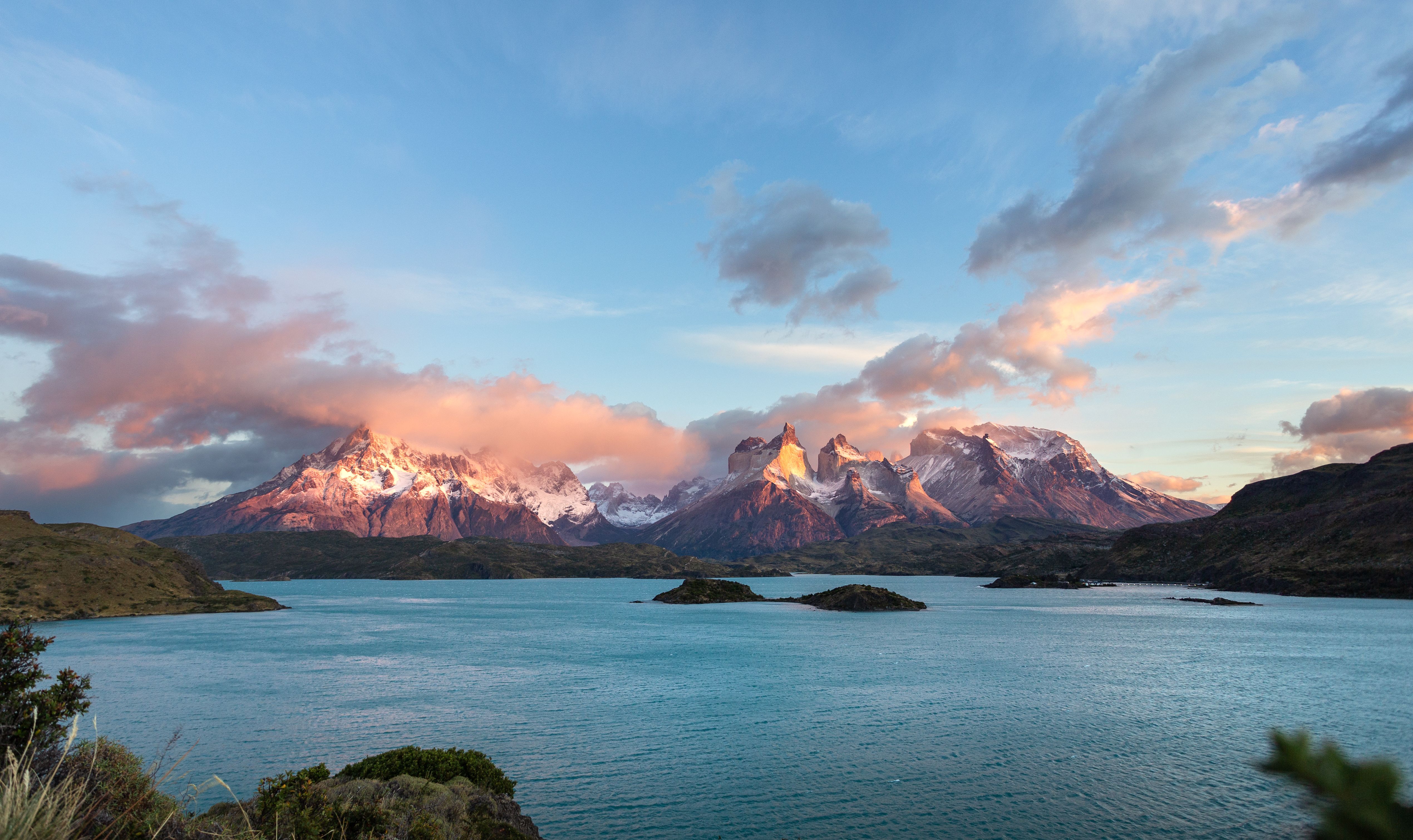 Epic sunrise at Torres del Paine with colorful clouds over mountain landscape and lake.
