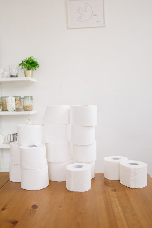 Free Bathroom Tissue Rolls on Wooden Table Stock Photo