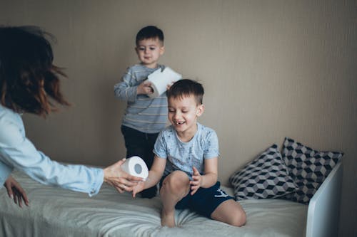 Free Kids Playing with Tissue Roll Stock Photo