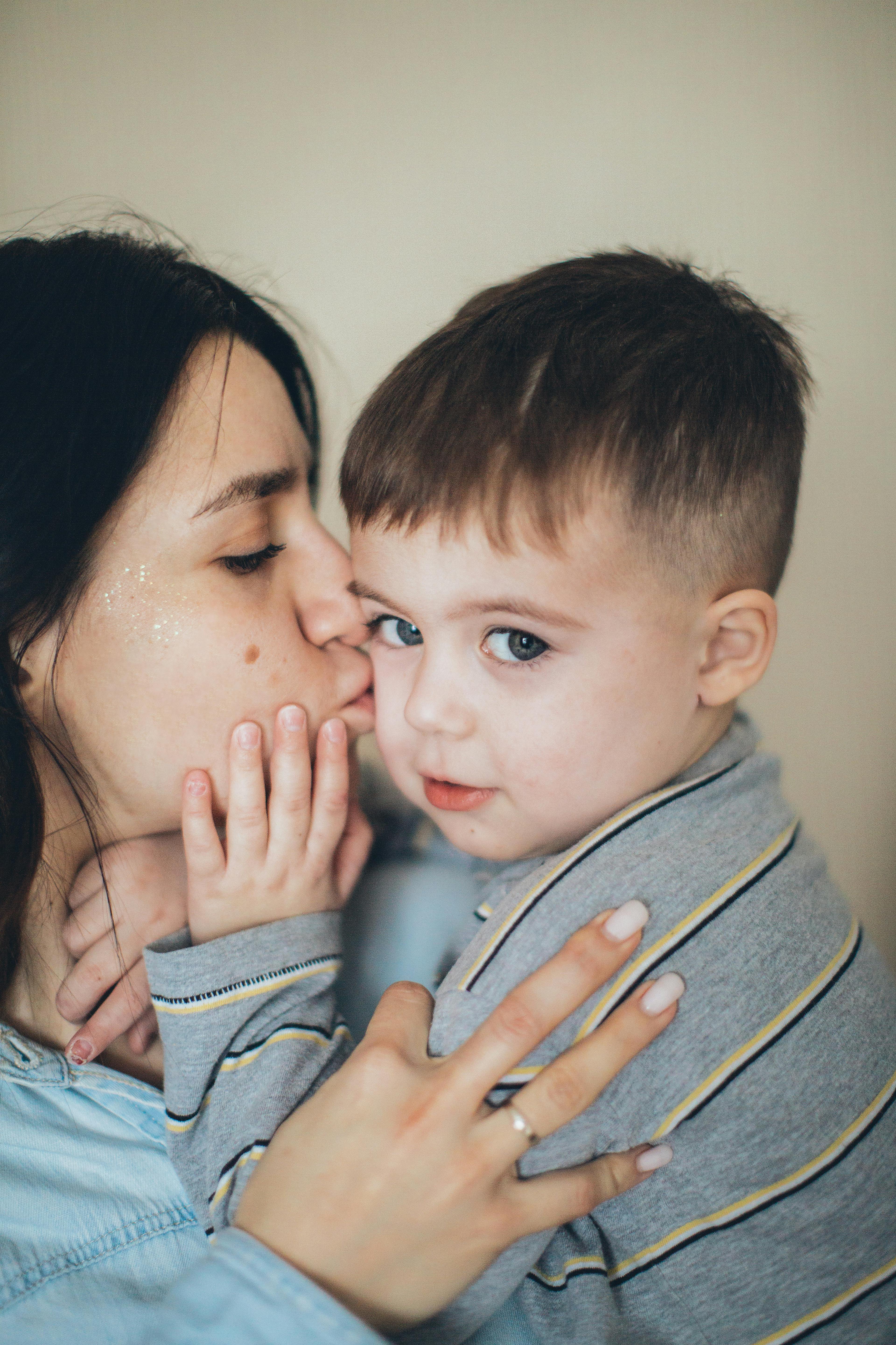 mommy kissing little boy