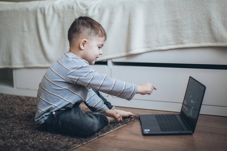 Little Boy Pointing On The Laptop